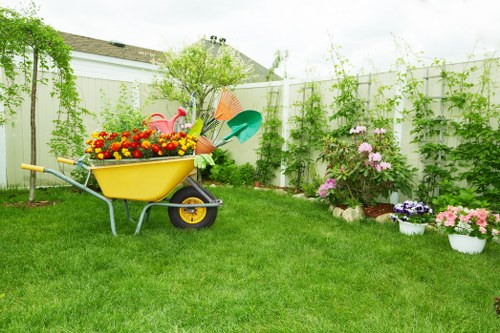 Man and van loading garden waste at a suburban property