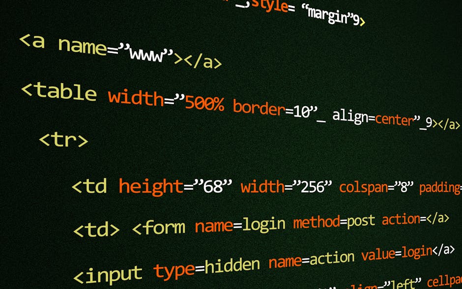 A close-up view of a person's hand using a black computer keyboard placed on a white desk, with a large monitor displaying lines of code in a programming environment. In the background, there are gard